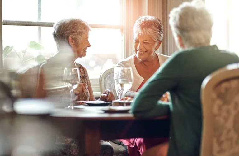 A group of seniors socializing by grabbing dinner together.