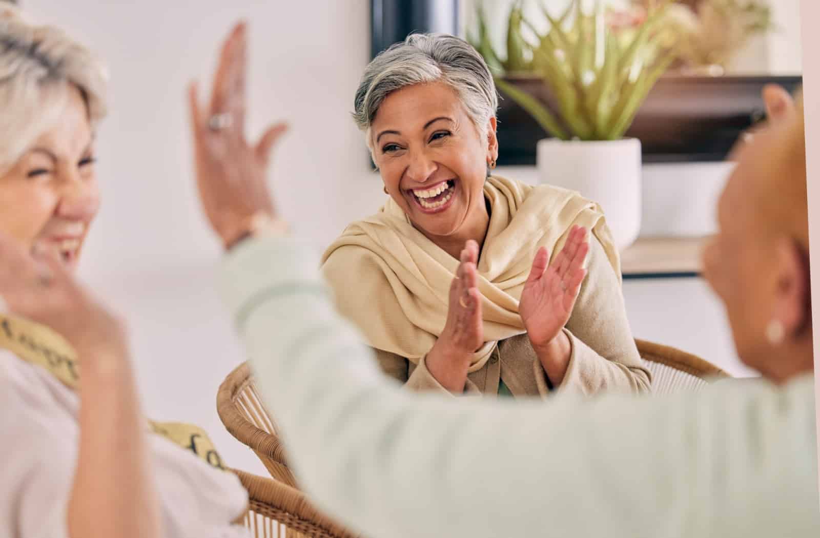 A group of seniors laughing together at a social event.