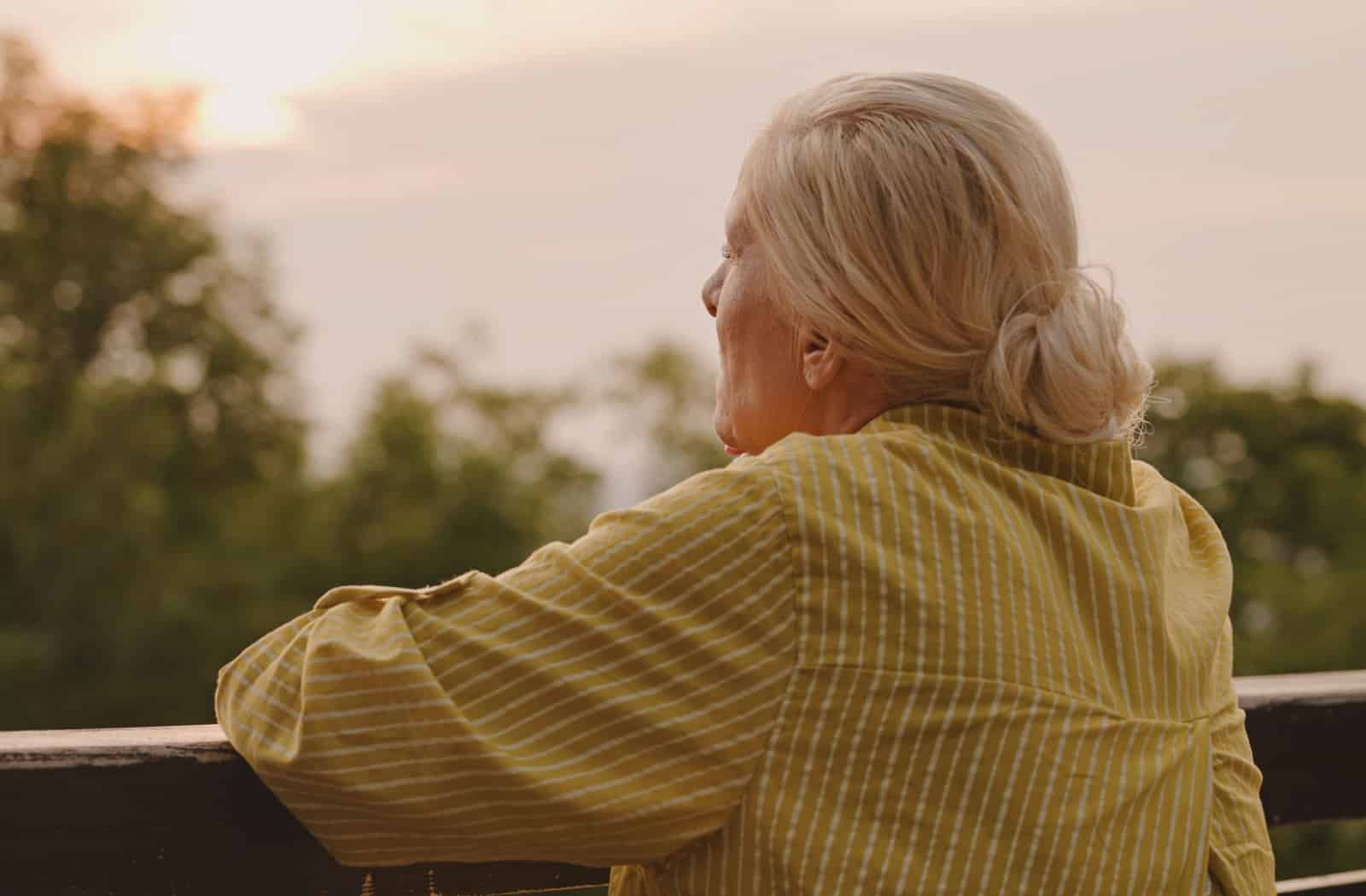 A person looking into the distance, thinking about whether they can leave their loved one with dementia alone.